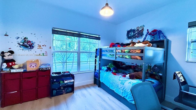 bedroom with baseboards and light wood finished floors