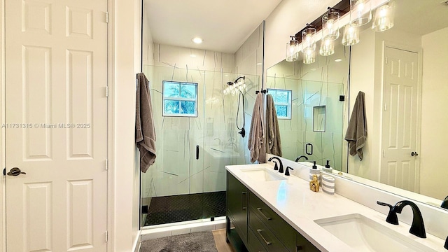 bathroom featuring double vanity, a sink, and a shower stall