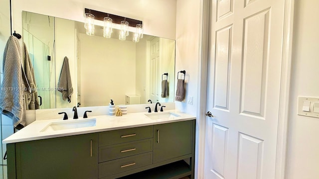 bathroom featuring double vanity, a shower stall, and a sink