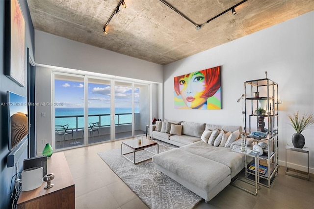 living room with a water view and rail lighting