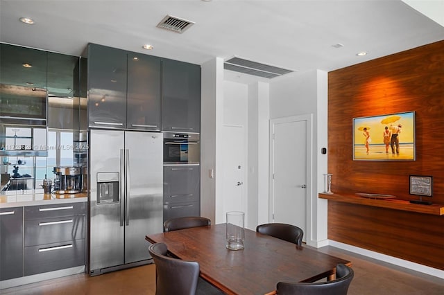 interior space with wood walls, visible vents, and recessed lighting