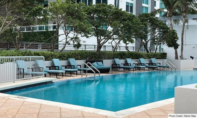 pool featuring fence, an outdoor hangout area, and a patio area