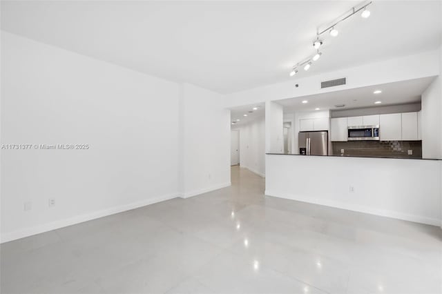 unfurnished living room with baseboards, visible vents, and recessed lighting