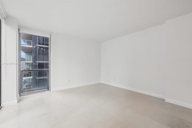 spare room featuring baseboards