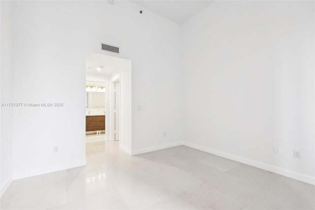 unfurnished room with light tile patterned floors, visible vents, and baseboards