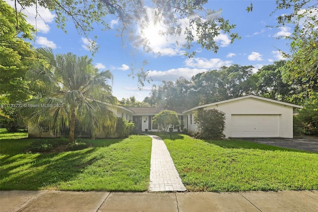 ranch-style house with a garage and a front lawn