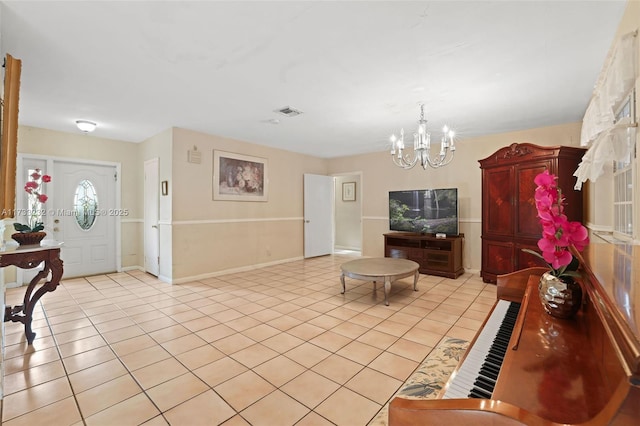 living room with light tile patterned flooring and a notable chandelier