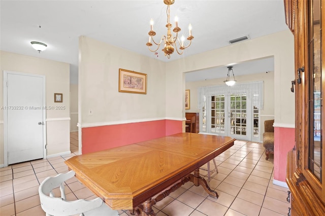 dining room featuring french doors, a chandelier, and light tile patterned flooring