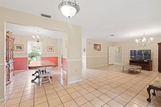 dining space with a notable chandelier and light tile patterned floors