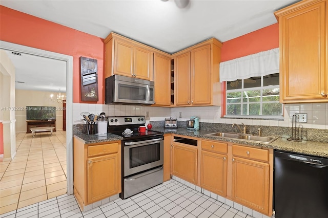 kitchen featuring light tile patterned flooring, appliances with stainless steel finishes, tasteful backsplash, sink, and a notable chandelier