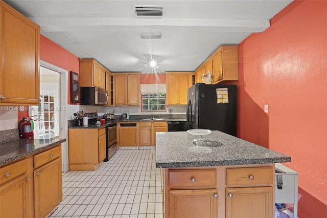 kitchen featuring sink, a center island, black appliances, dark stone counters, and beamed ceiling