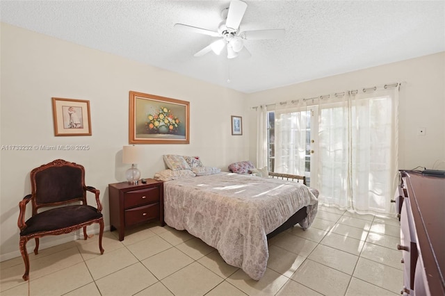 bedroom with light tile patterned floors, a textured ceiling, and ceiling fan