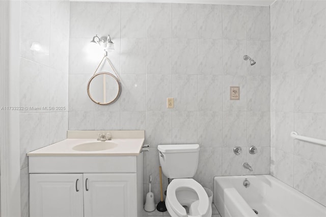 bathroom with vanity, tile walls, and toilet