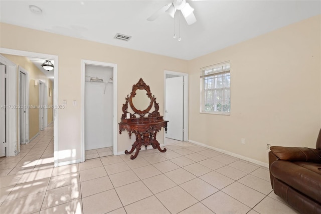 sitting room with light tile patterned flooring and ceiling fan