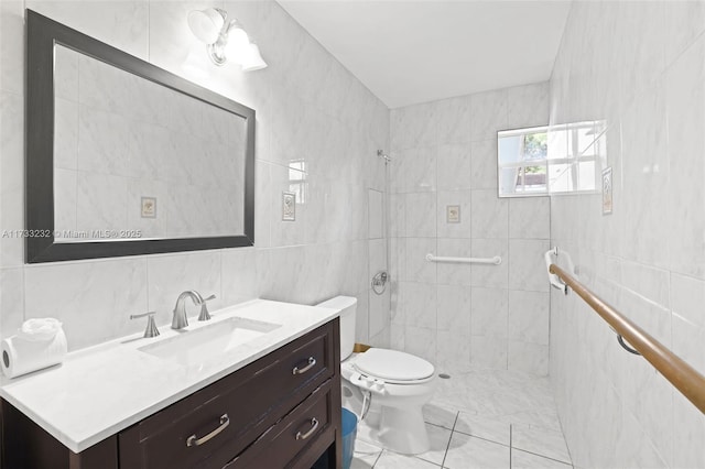 bathroom with tile walls, vanity, toilet, and walk in shower