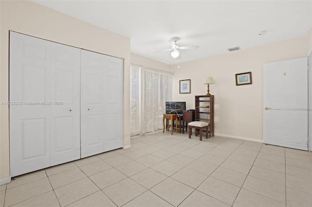 interior space featuring ceiling fan and light tile patterned floors