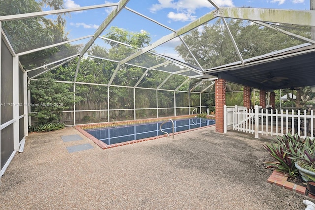 view of pool featuring ceiling fan, a lanai, and a patio area