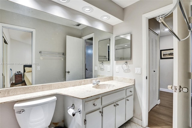 bathroom featuring vanity and toilet