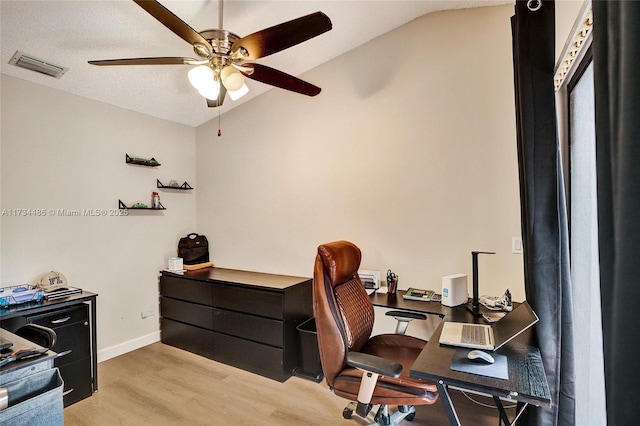 office area with light hardwood / wood-style flooring, a textured ceiling, vaulted ceiling, and ceiling fan