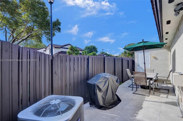 view of patio with a grill and central AC