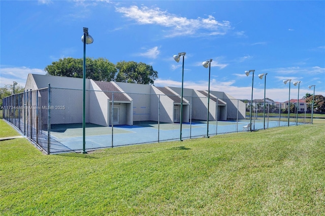 view of sport court featuring a yard