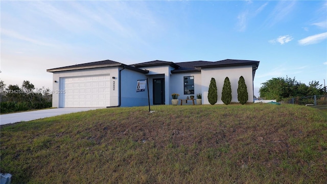 view of front of property featuring a garage and a front yard