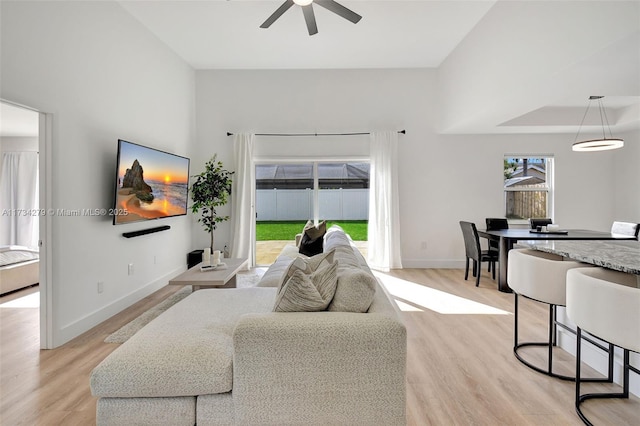 living room featuring light hardwood / wood-style floors and ceiling fan