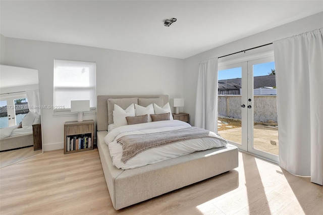 bedroom with light hardwood / wood-style flooring, access to outside, and french doors