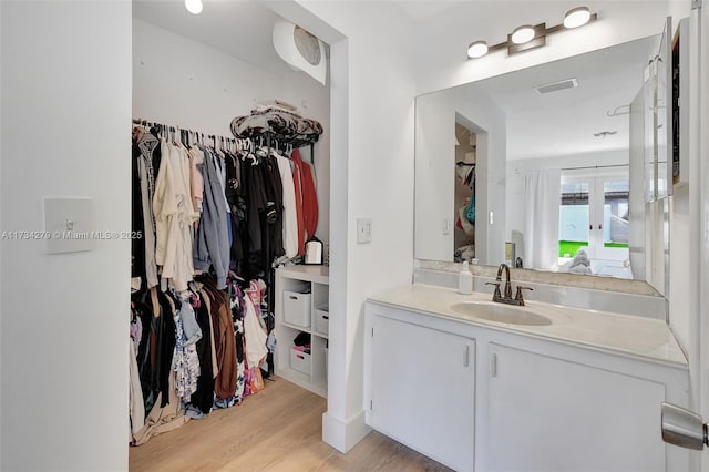 bathroom with wood-type flooring and vanity