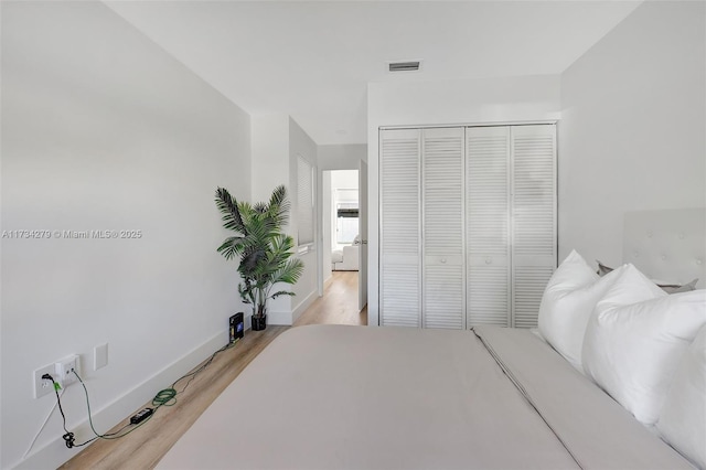 bedroom featuring light hardwood / wood-style floors and a closet