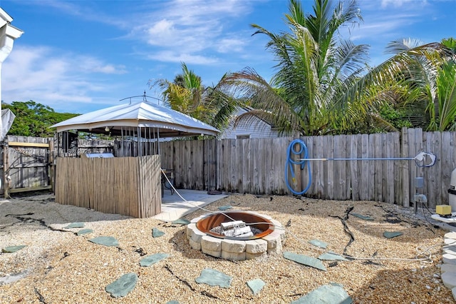 view of yard featuring a gazebo and an outdoor fire pit