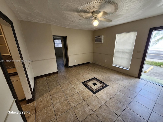 spare room featuring tile patterned flooring, ceiling fan, a wall mounted AC, and a textured ceiling