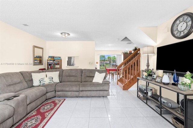 living room with light tile patterned floors and a textured ceiling