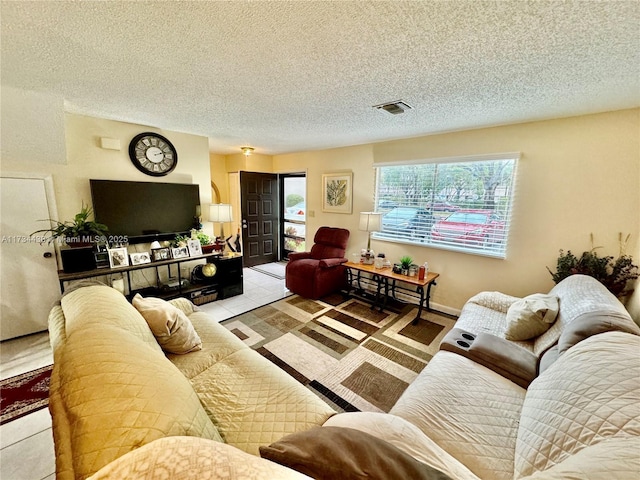 tiled living room with a wealth of natural light and a textured ceiling