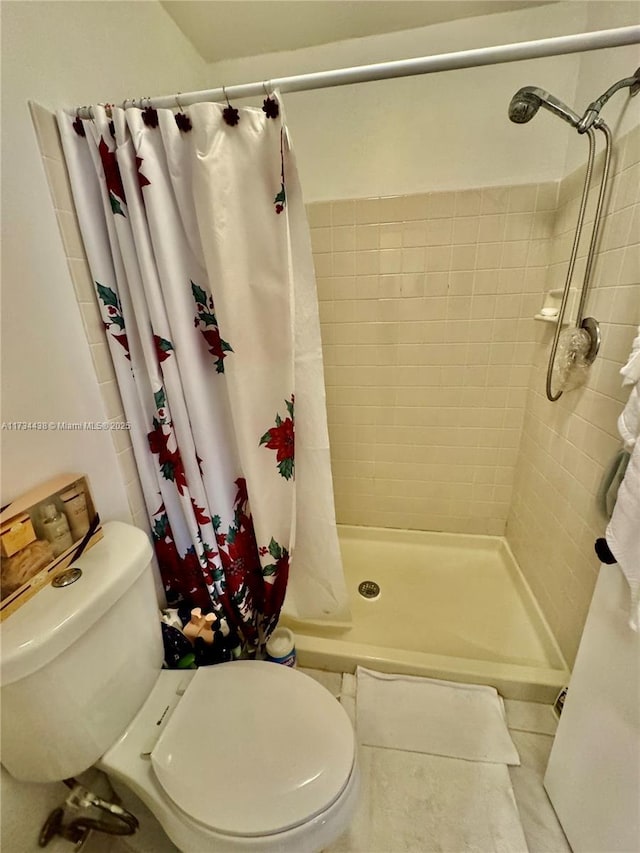 bathroom featuring tile patterned floors, toilet, and a shower with shower curtain