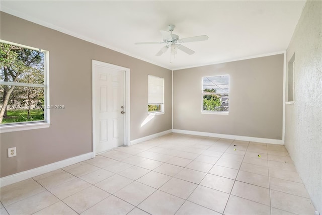 unfurnished room featuring ornamental molding, plenty of natural light, baseboards, and a ceiling fan