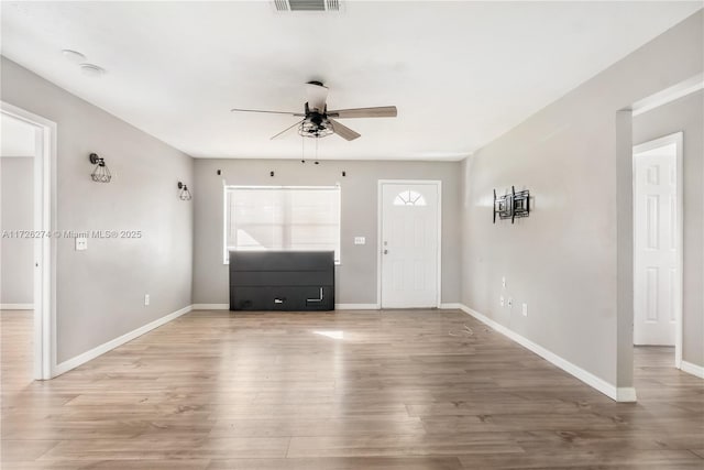 entrance foyer with visible vents, ceiling fan, light wood-style flooring, and baseboards