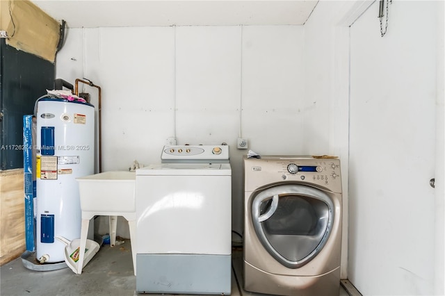 washroom with laundry area, water heater, and separate washer and dryer