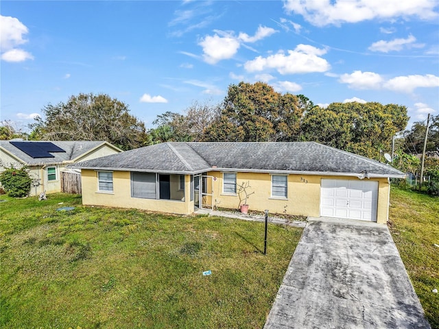 ranch-style home featuring a front yard, driveway, an attached garage, and stucco siding