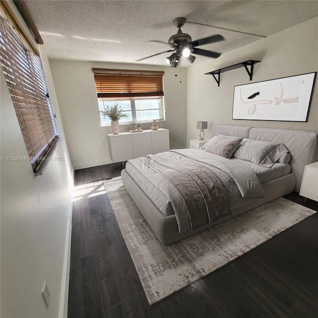 bedroom featuring a textured ceiling, dark wood-type flooring, and ceiling fan