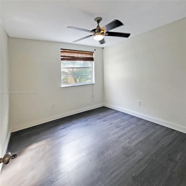 empty room featuring dark hardwood / wood-style flooring and ceiling fan