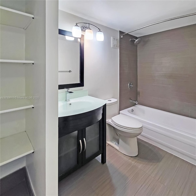 full bathroom featuring vanity, toilet, and tiled shower / bath