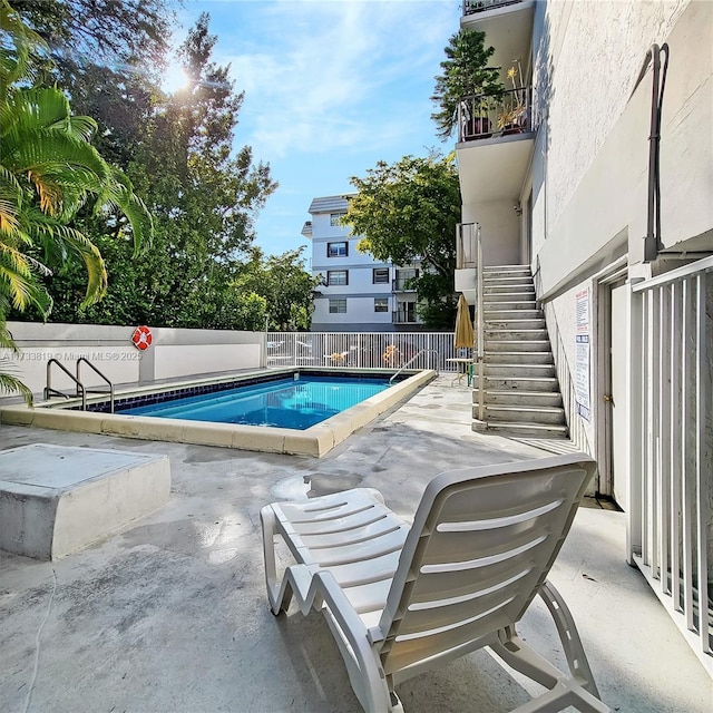 view of swimming pool with a patio area