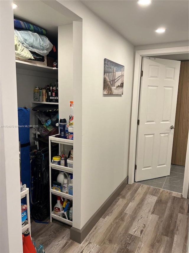 hallway with hardwood / wood-style flooring