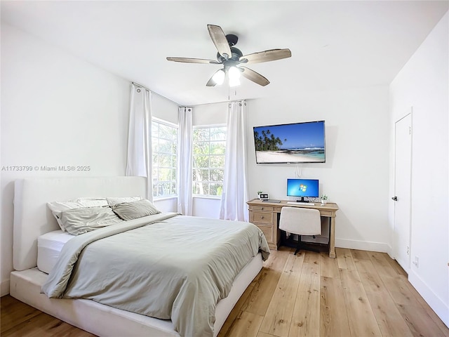 bedroom with ceiling fan and light hardwood / wood-style flooring