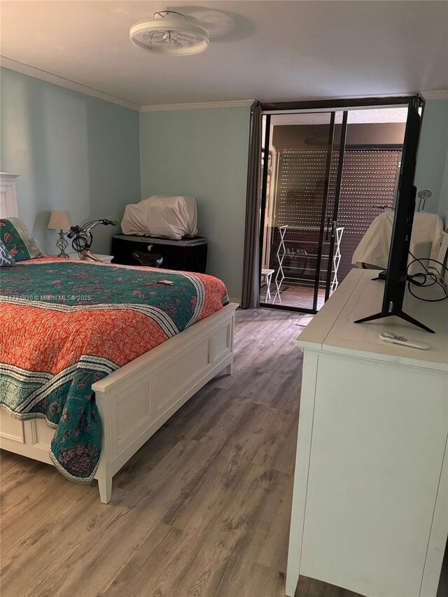 bedroom with crown molding and dark wood-type flooring