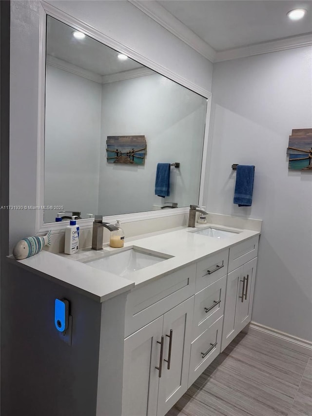 bathroom featuring ornamental molding, hardwood / wood-style floors, and vanity