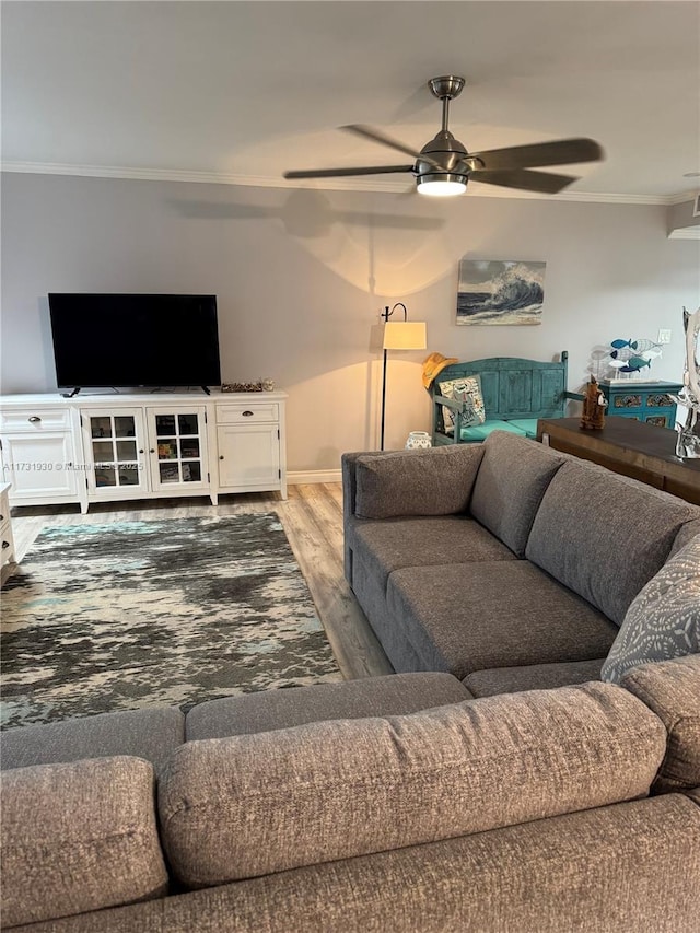 living room with crown molding, ceiling fan, and wood-type flooring