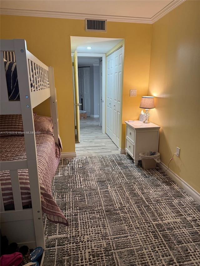 bedroom featuring ornamental molding and a closet