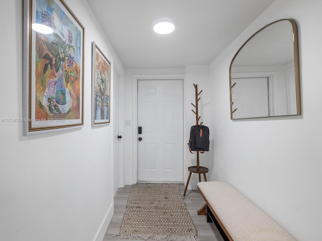 corridor with light hardwood / wood-style floors